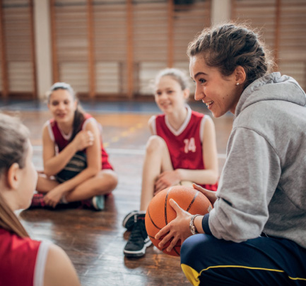 coach talking with her basketball team