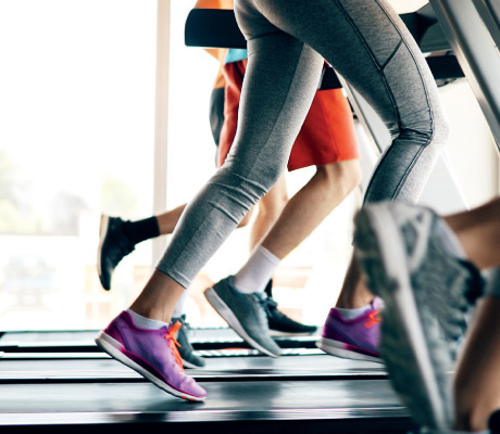 view of people's legs running on treadmills