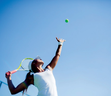 woman about to serve a tennis ball