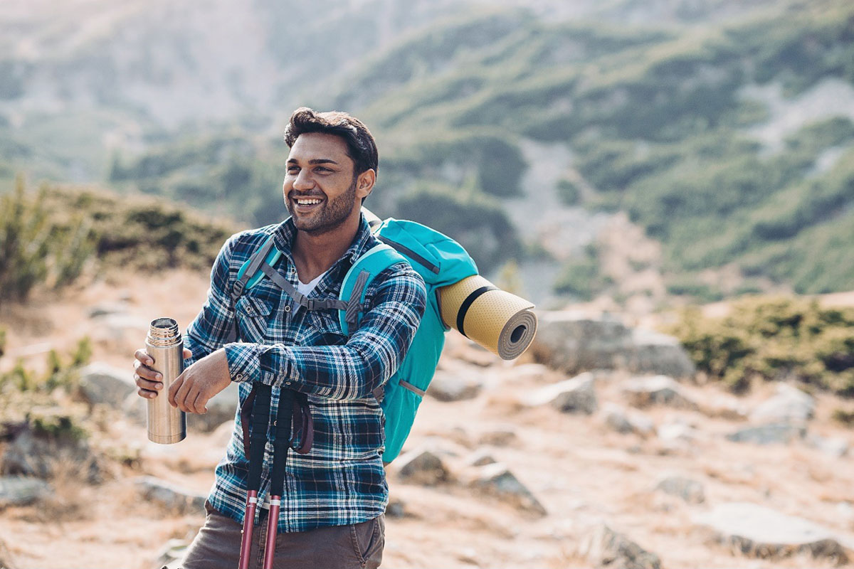 hiker with open thermos